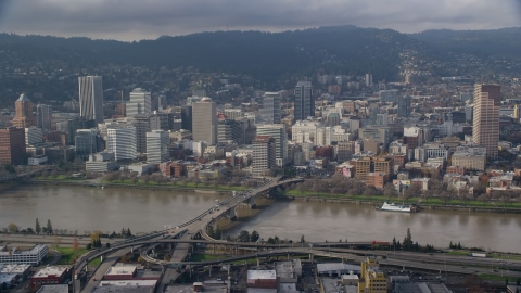 AX153_121.0000284F - Aerial stock photo of Downtown Portland, Oregon across the Willamette River and Morrison Bridge
