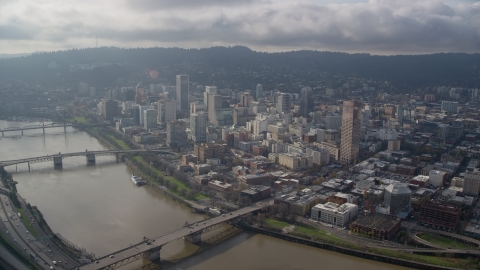 AX153_122.0000253F - Aerial stock photo of Three bridges spanning the Willamette River and skyscrapers in Downtown Portland, Oregon
