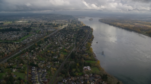 AX153_141.0000021F - Aerial stock photo of Suburban riverfront houses by Highway 14 in Vancouver, Washington