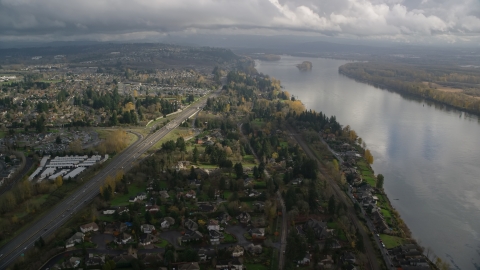 AX153_142.0000206F - Aerial stock photo of Highway 14 and suburban homes on the Columbia River in Vancouver, Washington
