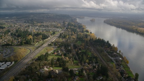 AX153_142.0000335F - Aerial stock photo of Highway 14 near suburban homes on the Columbia River in Vancouver, Washington