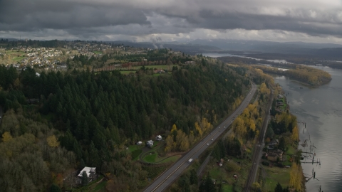 AX153_146.0000208F - Aerial stock photo of High above Highway 14 and hilltop suburban homes, autumn, Camas, Washington