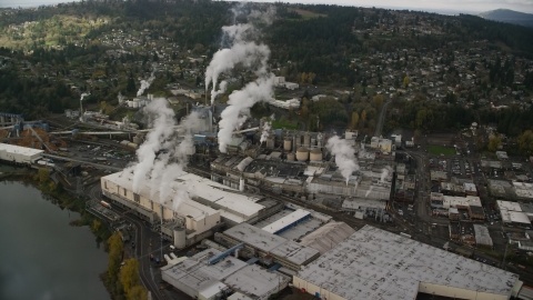 AX153_153.0000255F - Aerial stock photo of The Georgia Pacific Paper Mill with steam rising in Camas, Washington