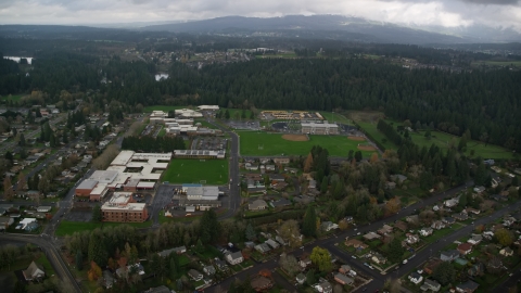 AX153_155.0000018F - Aerial stock photo of School campuses and sports fields in Camas, Washington