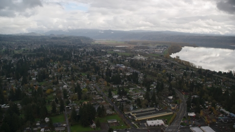 AX153_160.0000281F - Aerial stock photo of Strip mall near a suburban neighborhood in Washougal, Washington