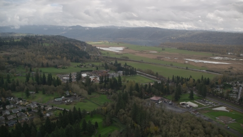 AX153_176.0000111F - Aerial stock photo of Train traveling through countryside, Washougal, Washington