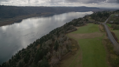 AX153_188.0000347F - Aerial stock photo of Cliff top trees overlooking the Columbia River, Washington