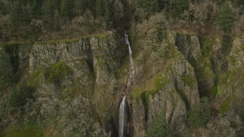 AX154_011.0000174F - Aerial stock photo of A waterfall on a steep cliff in Columbia River Gorge, Washington