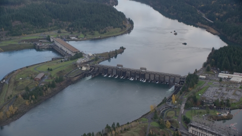 AX154_038.0000311F - Aerial stock photo of Bonneville Dam structures in the Columbia River Gorge