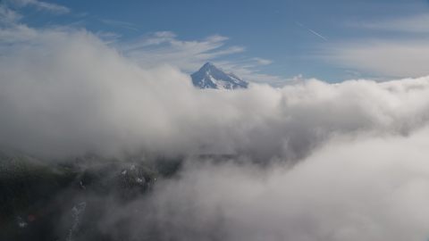 AX154_060.0000000F - Aerial stock photo of Mount Hood, visible above a layer of thick clouds, Cascade Range, Oregon