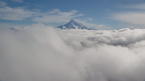 AX154_062.0000000F - Aerial stock photo of A thick cloud layer around snowy Mount Hood, Cascade Range, Oregon