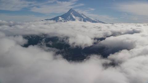 AX154_067.0000251F - Aerial stock photo of The Mount Hood summit with snow and clouds, Cascade Range, Oregon