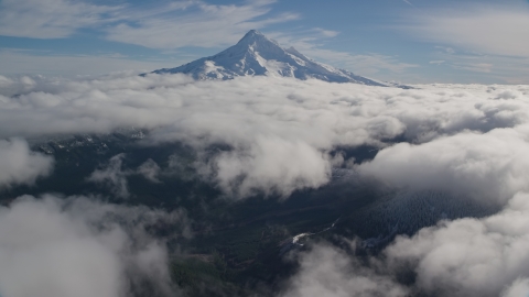 AX154_068.0000206F - Aerial stock photo of A break in the clouds near the snowy summit of Mount Hood, Cascade Range, Oregon
