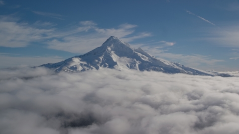 AX154_070.0000206F - Aerial stock photo of Mount Hood's snowy summit with low clouds, Mount Hood, Cascade Range, Oregon