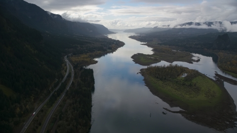 AX154_180.0000321F - Aerial stock photo of Columbia River and the I-84 highway by islands in the Columbia River Gorge