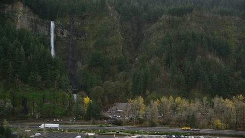 AX154_189.0000235F - Aerial stock photo of The I-84 highway below Multnomah Falls on a cliff face of the Columbia River Gorge