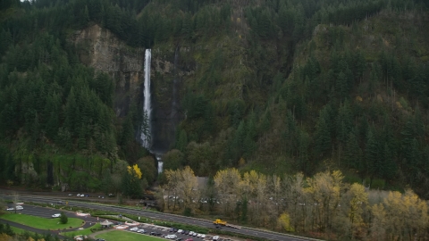 AX154_189.0000297F - Aerial stock photo of I-84 highway by Multnomah Falls on a cliff face of the Columbia River Gorge