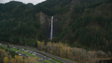 AX154_189.0000367F - Aerial stock photo of Interstate 84 and Multnomah Falls on a cliff face of the Columbia River Gorge