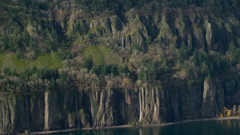 AX154_194.0000136F - Aerial stock photo of Four waterfalls on steep green cliffs on the Washington side of Columbia River Gorge