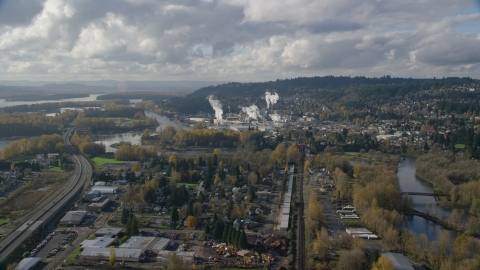 AX154_210.0000271F - Aerial stock photo of Homes near the Washougal River and the Georgia Pacific Paper Mill in Camas, Washington