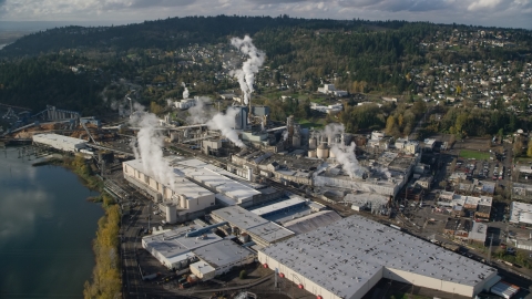 AX154_213.0000037F - Aerial stock photo of Steam rising from the Georgia Pacific Paper Mill in Camas, Washington