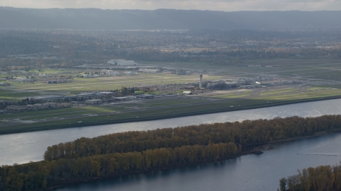 AX154_217.0000223F - Aerial stock photo of Portland International Airport seen from across the Columbia River