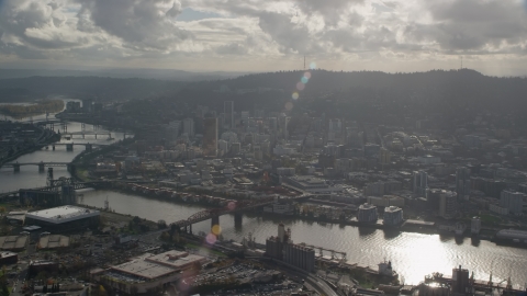 AX154_227.0000000F - Aerial stock photo of The Willamette River and Downtown Portland, Oregon with godrays shining down