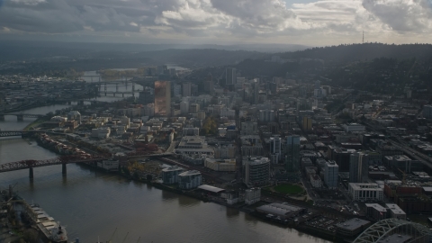 AX154_227.0000336F - Aerial stock photo of Willamette River and Downtown Portland, Oregon with godrays shining down from the clouds