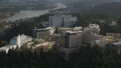 AX154_248.0000000F - Aerial stock photo of Oregon Health and Science University hospital complex in the hills over Portland, Oregon