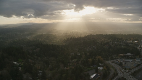 AX155_118.0000000F - Aerial stock photo of Godrays shining on neighborhoods and Highway 26, Southwest Portland, Oregon