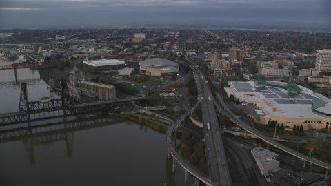 AX155_175.0000000F - Aerial stock photo of I-5 to Veterans Memorial Colosseum and Moda Center in Lloyd District, Portland, Oregon, sunset