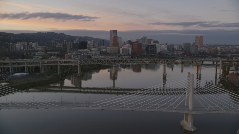 AX155_191.0000000F - Aerial stock photo of Downtown Portland skyline and Marquam Bridge seen from Tilikum Crossing at sunset, Oregon