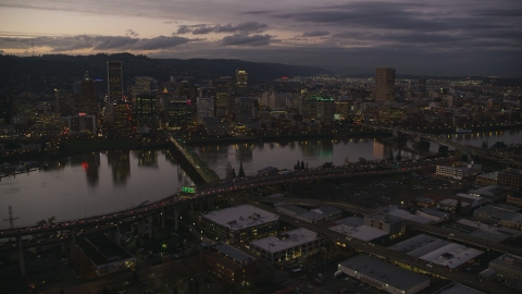AX155_251.0000324F - Aerial stock photo of Skyscrapers and bridges over the Willamette River at sunset, Downtown Portland, Oregon