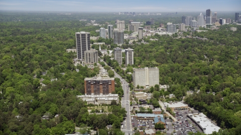AX36_049.0000120F - Aerial stock photo of Peachtree Road through office buildings among wooded area, Bulkhead, Georgia