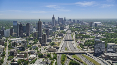 AX36_086.0000141F - Aerial stock photo of Downtown Connector toward Midtown Atlanta skyscrapers, hazy, Georgia