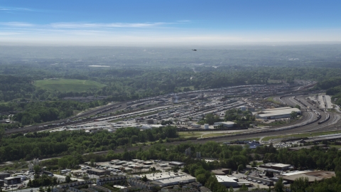 AX37_085.0000025F - Aerial stock photo of Train yard surrounded by green trees, Atlanta, Georgia
