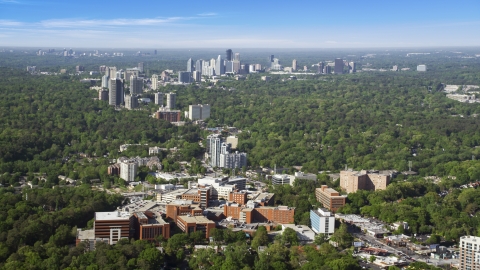 AX38_007.0000035F - Aerial stock photo of Wide shot of skyscrapers and high-rises surrounded by forests, Buckhead, Georgia