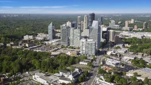 AX38_012.0000306F - Aerial stock photo of Skyscrapers overlooking forests, Buckhead, Georgia