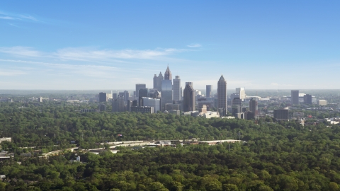 AX38_027.0000048F - Aerial stock photo of Distant shot of Midtown Atlanta skyscrapers beyond trees, Buckhead, Georgia