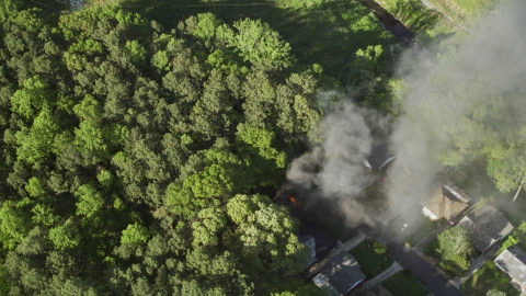 AX38_037.0000175F - Aerial stock photo of Smoke rising from a burning home, West Atlanta, Georgia