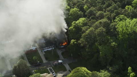 AX38_045.0000458F - Aerial stock photo of Rising smoke from a burning house, West Atlanta, Georgia