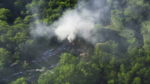AX38_050.0000229F - Aerial stock photo of Smoke rising from a burning home, West Atlanta, Georgia