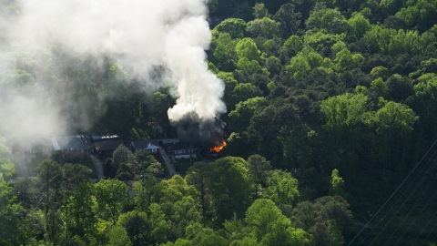 AX38_052.0000000F - Aerial stock photo of Smoke and flames rising from a burning home, West Atlanta, Georgia