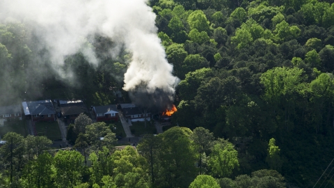 AX38_052.0000129F - Aerial stock photo of Smoke and flames rising from a burning home, West Atlanta, Georgia