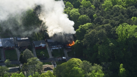 AX38_052.0000276F - Aerial stock photo of Smoke and flames from a burning home, West Atlanta, Georgia