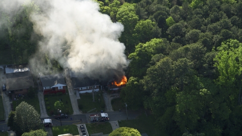 AX38_052.0000382F - Aerial stock photo of Smoke and flames from a burning home, West Atlanta, Georgia