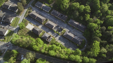 AX38_081.0000041F - Aerial stock photo of Bird's eye view of abandoned buildings among trees, Atlanta, Georgia