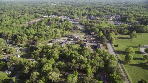 AX38_082.0000096F - Aerial stock photo of Abandoned buildings among trees, West Atlanta