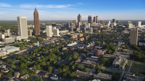 AX39_028.0000034F - Aerial stock photo of Midtown and Downtown Atlanta skyscrapers behind Bobby Dodd Stadium, Atlanta, Georgia