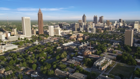 AX39_028.0000127F - Aerial stock photo of Midtown and Downtown Atlanta skyscrapers behind the Bobby Dodd Sports Stadium, Atlanta, Georgia
